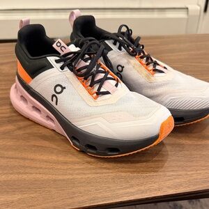 On Running Women's Black, White, and Orange Sneakers
